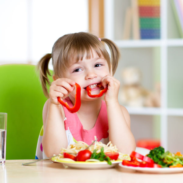 child eating healthy food in kindergarten or at home